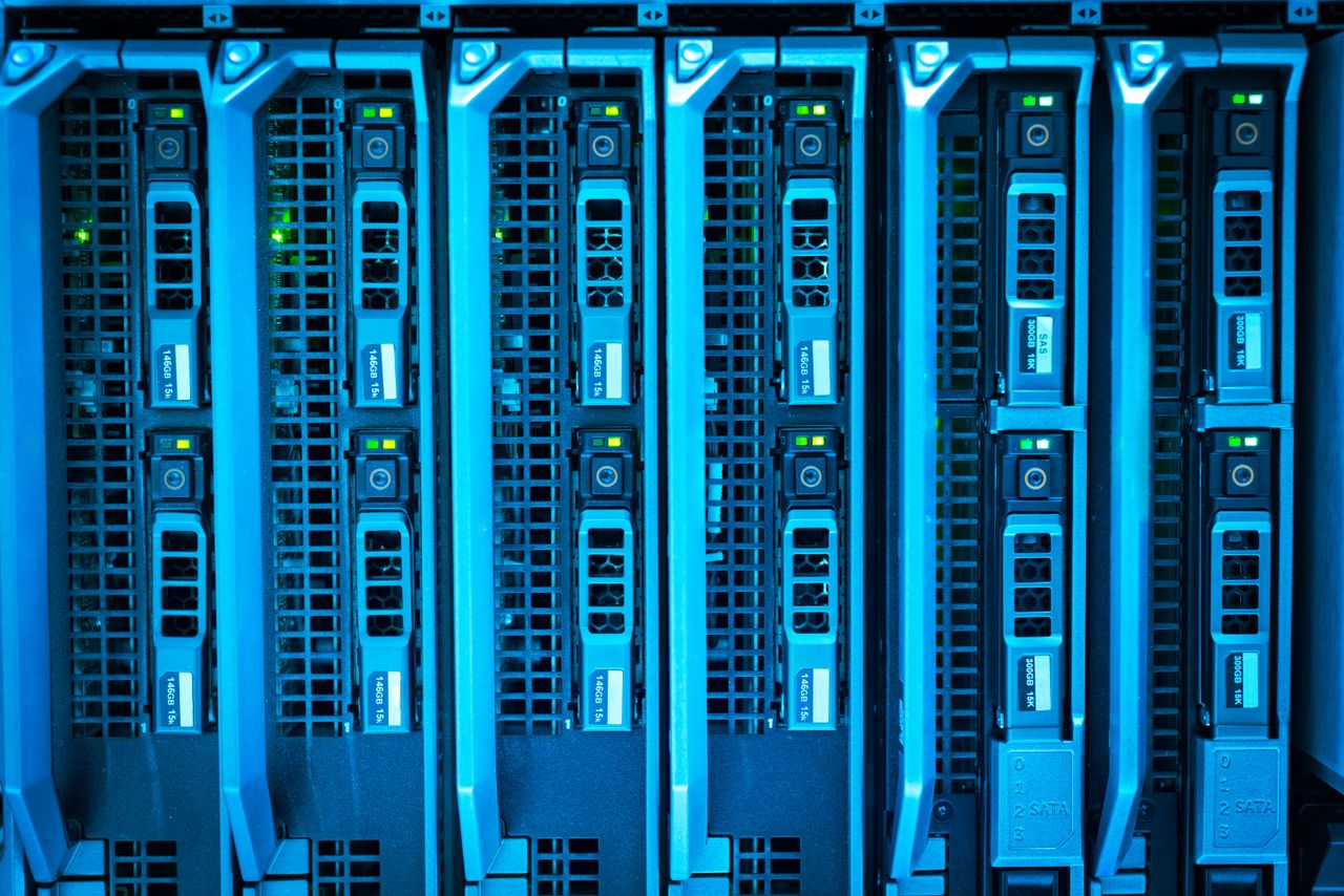 heros-img Detailed image of illuminated server racks showcasing modern technology infrastructure.