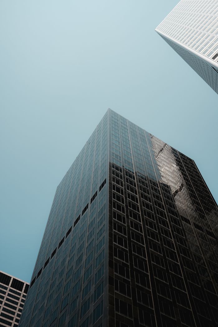 Modern skyscrapers towering in a clear urban skyline, capturing contemporary architecture's elegance.