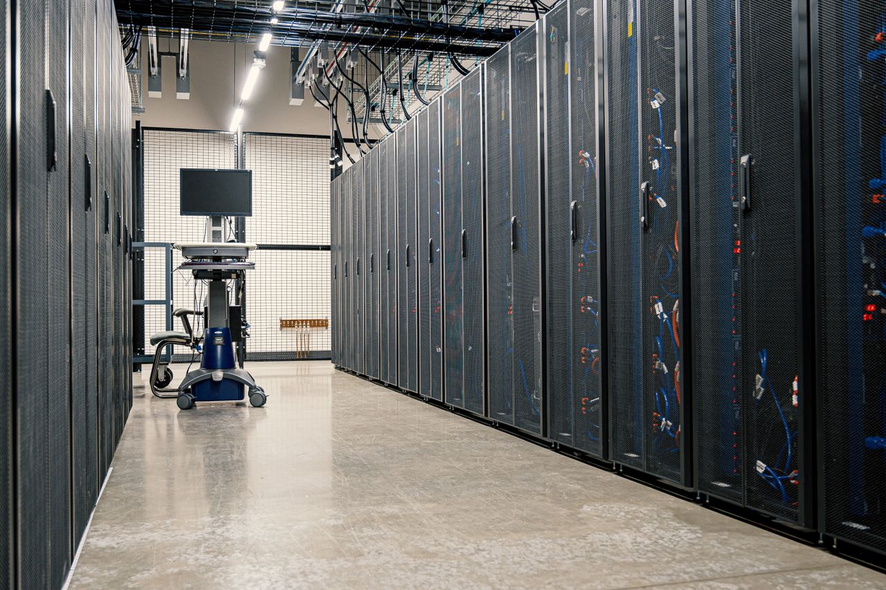 about-us Steel framework cabinets housing servers networking devices and cables in contemporary equipped data center